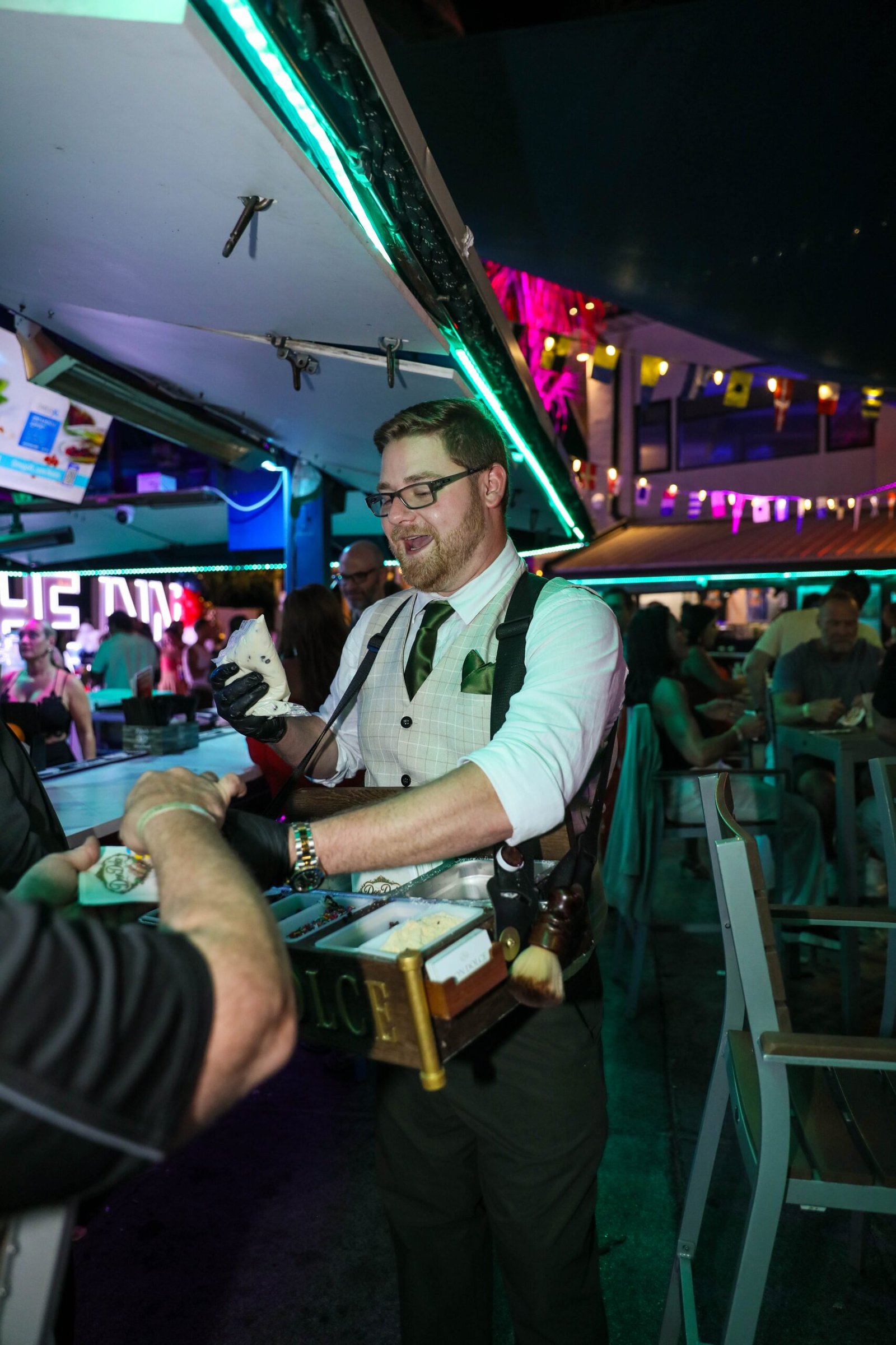 The Dolces serving a guest from a roaming cannoli caddy at Chesapeake Inn's 30th Anniversary in Chesapeake City, Maryland.